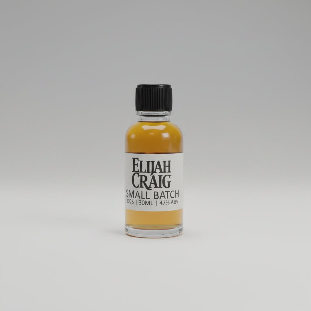 Bottle of Elijah Craig small batch whiskey on a table with a blurred background