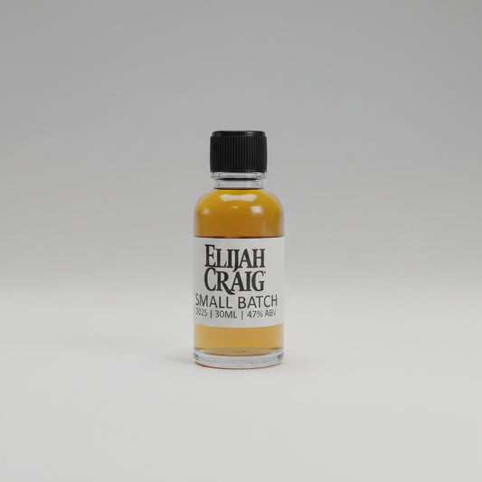 Bottle of Elijah Craig small batch whiskey on a table with a blurred background