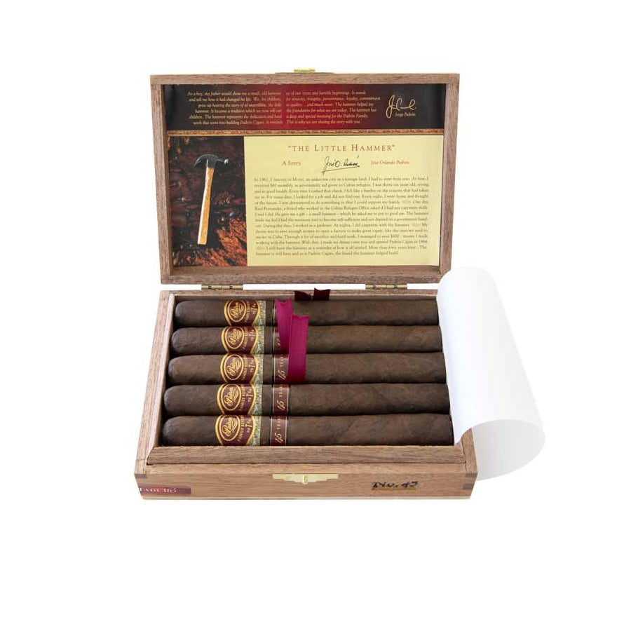 Open wooden box of cigars with a purple band on a white background