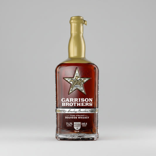 Bottle of Garrison Brothers Texas Straight Bourbon Whiskey with a gold cap and star logo.