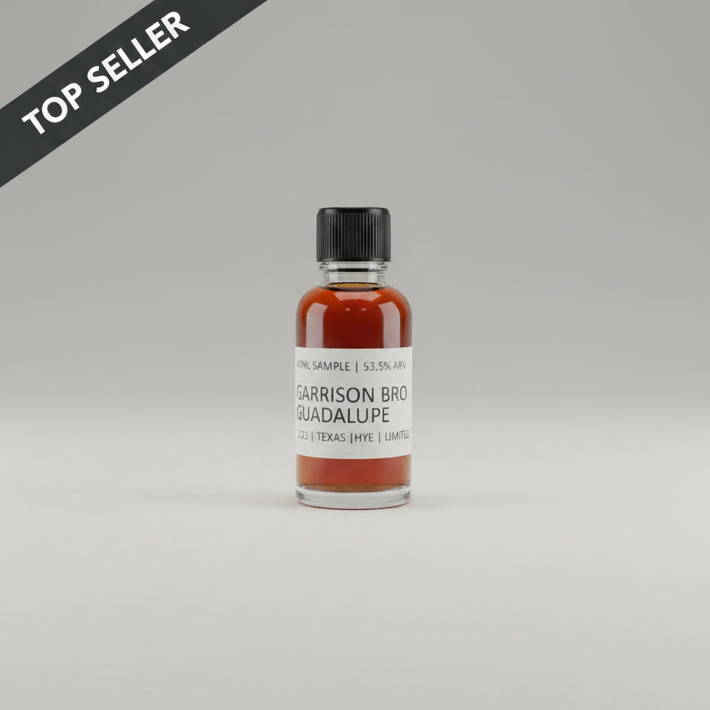 Small bottle of Garrison Brothers Guadalupe whiskey on a beige background