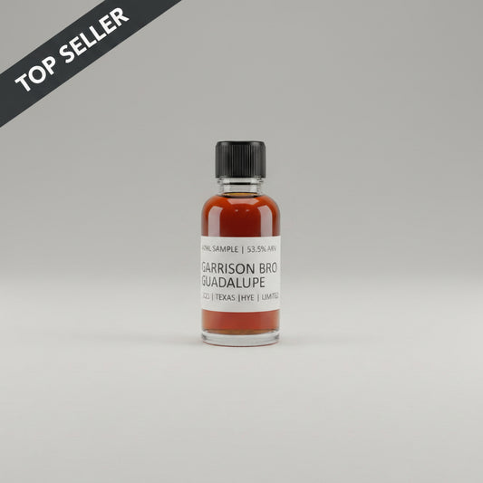 Small bottle of Garrison Brothers Guadalupe whiskey on a beige background