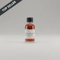 Small bottle of Garrison Brothers Guadalupe whiskey on a beige background