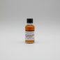 Small bottle of Garrison Brothers Honeydew on a beige background