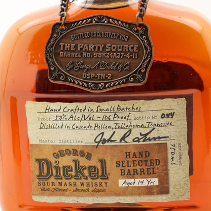 Close-up of a George Dickel Sour Mash Whisky bottle with a label and decorative tag.
