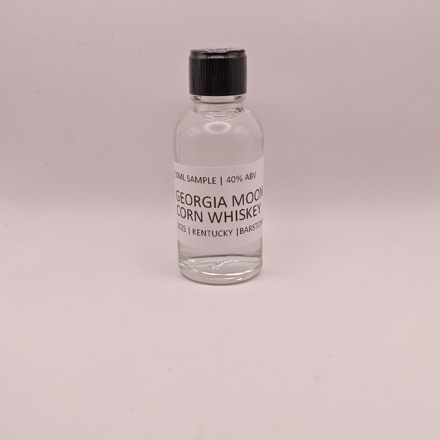 Small bottle of Georgia Moon Corn Whiskey on a light gray background