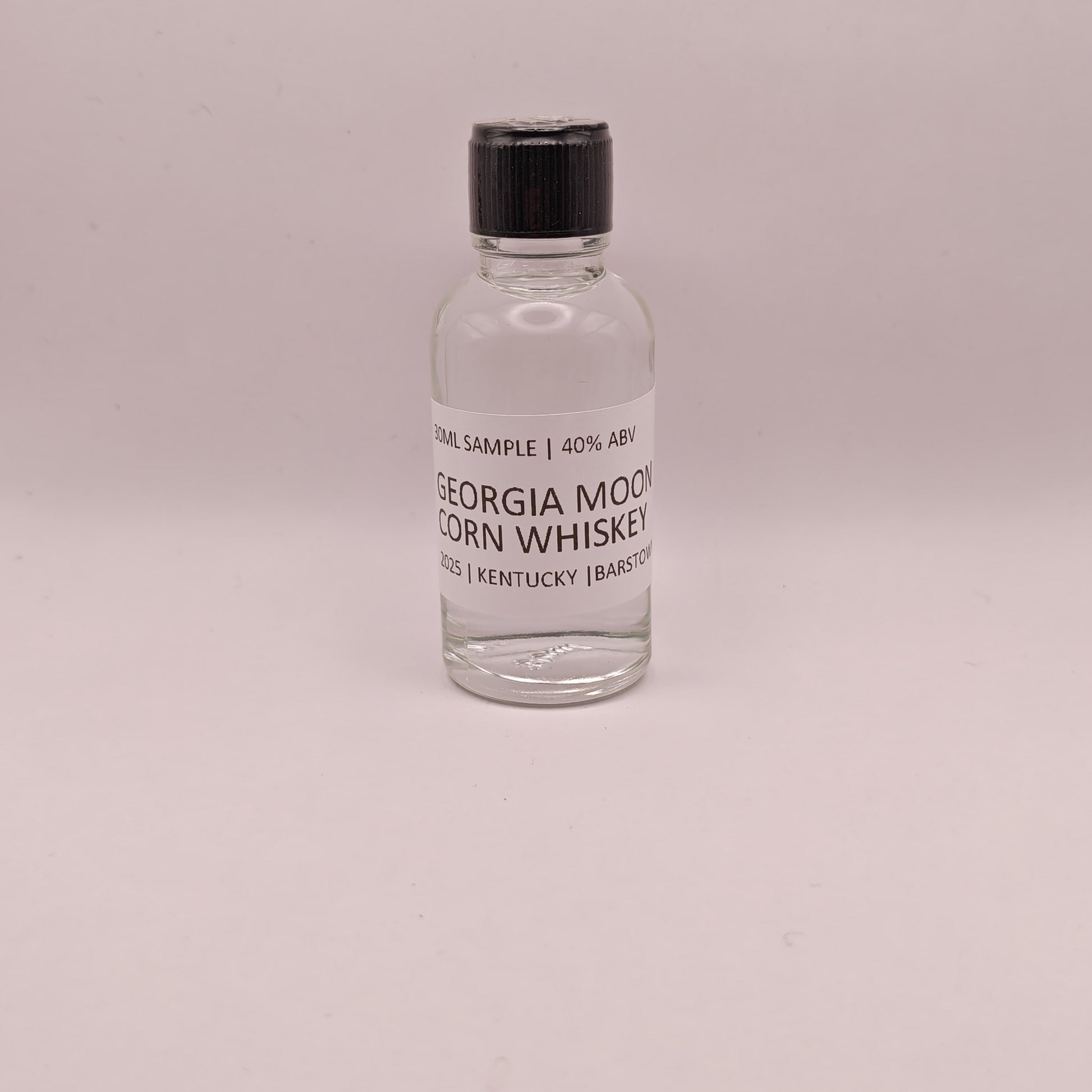 Small bottle of Georgia Moon Corn Whiskey on a light gray background