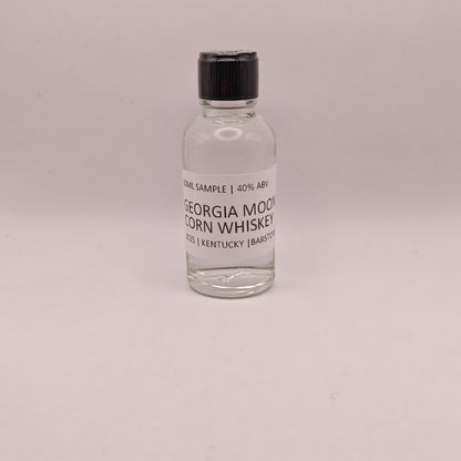 Small bottle of Georgia Moon Corn Whiskey on a light gray background