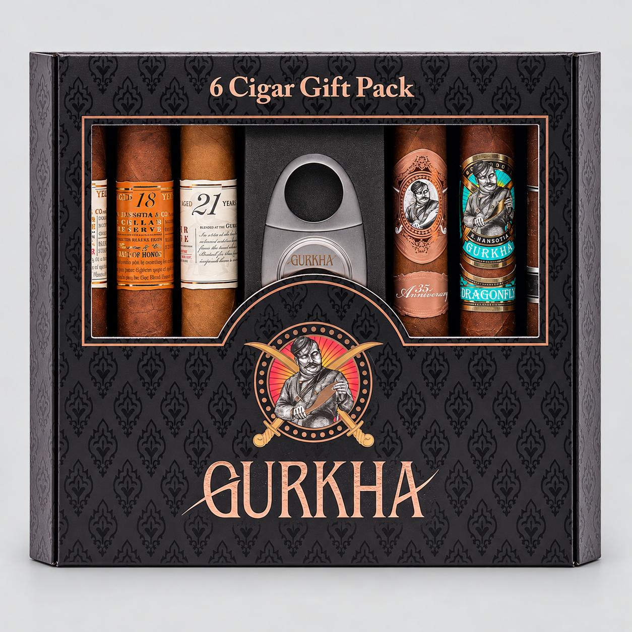 A black Gurkha 6 Cigar Gift Pack box containing six cigars and a silver cigar cutter, shown on a light gray background.