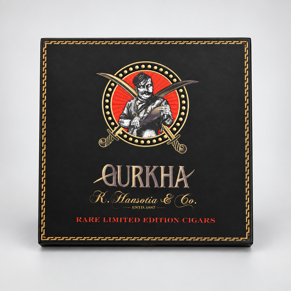 A square black cigar box with ornate gold border detailing and a central vintage-style illustration of a man holding a cigar, with the text 'QURKHA', 'R. Hansotia & Co.