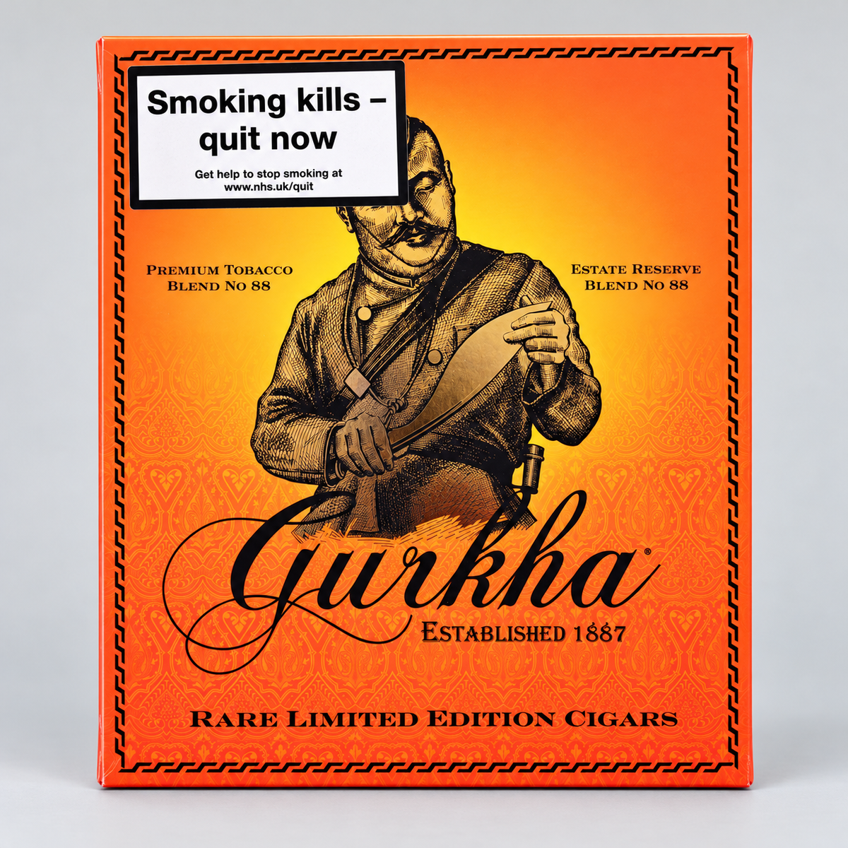 A rectangular box of Gurkha Rare Limited Edition Cigars, featuring a vibrant orange and yellow gradient background with a vintage-style illustration of a man holding a cigar. A white warning label at the top left reads 'Smoking kills - quit now'.