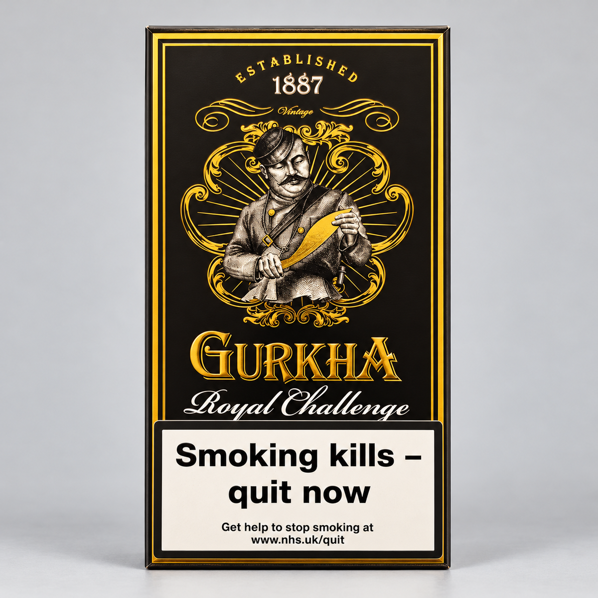 A rectangular Gurkha Royal Challenge cigarette pack box shown upright on a light gray background. The box is black with ornate gold detailing, featuring an illustrated figure holding a yellow-green object, the text 'ESTABLISHED 1887 Vintage', 'GURKHA', and 'Royal Challenge', plus a large smoking-health warning panel at the bottom.