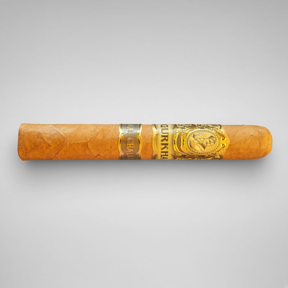 A single orange-brown cigar with a gold and silver band, featuring the brand name 'COQUIMBE' and a crest, set against a neutral light gray background.