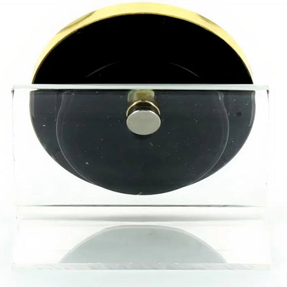 Black HYDRO object with gold accents on a white background