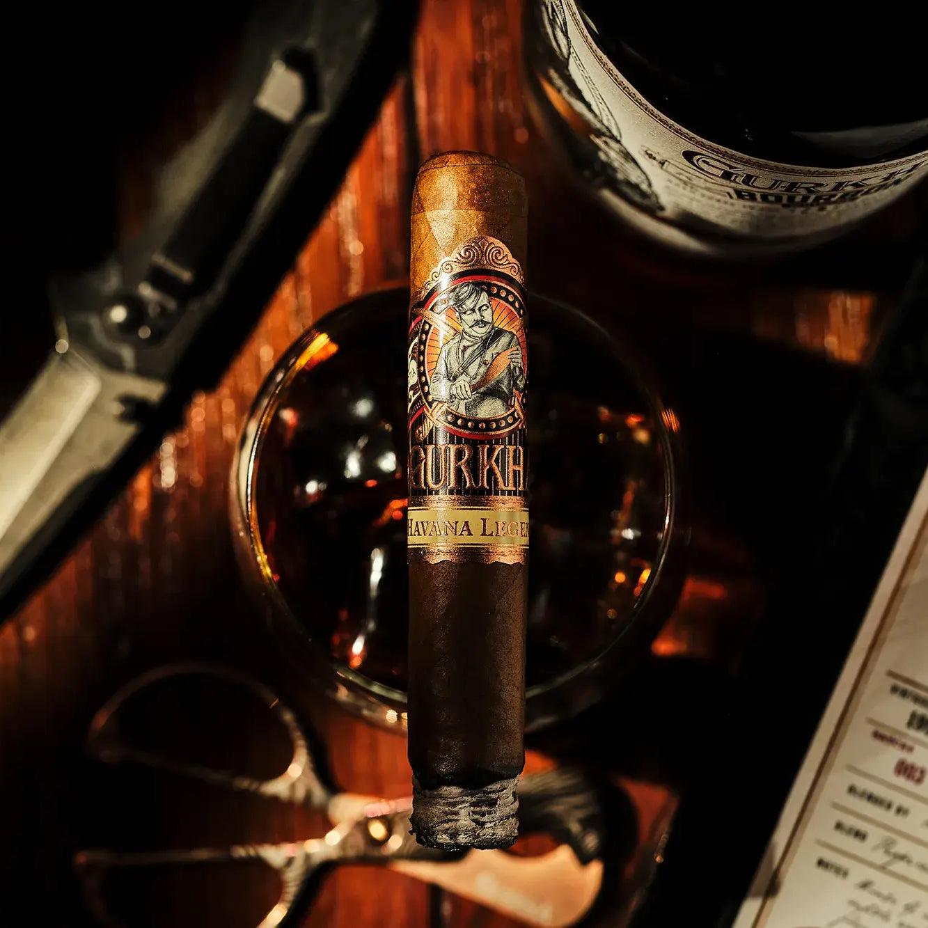 Cigar with a label, and glass on a wooden surface