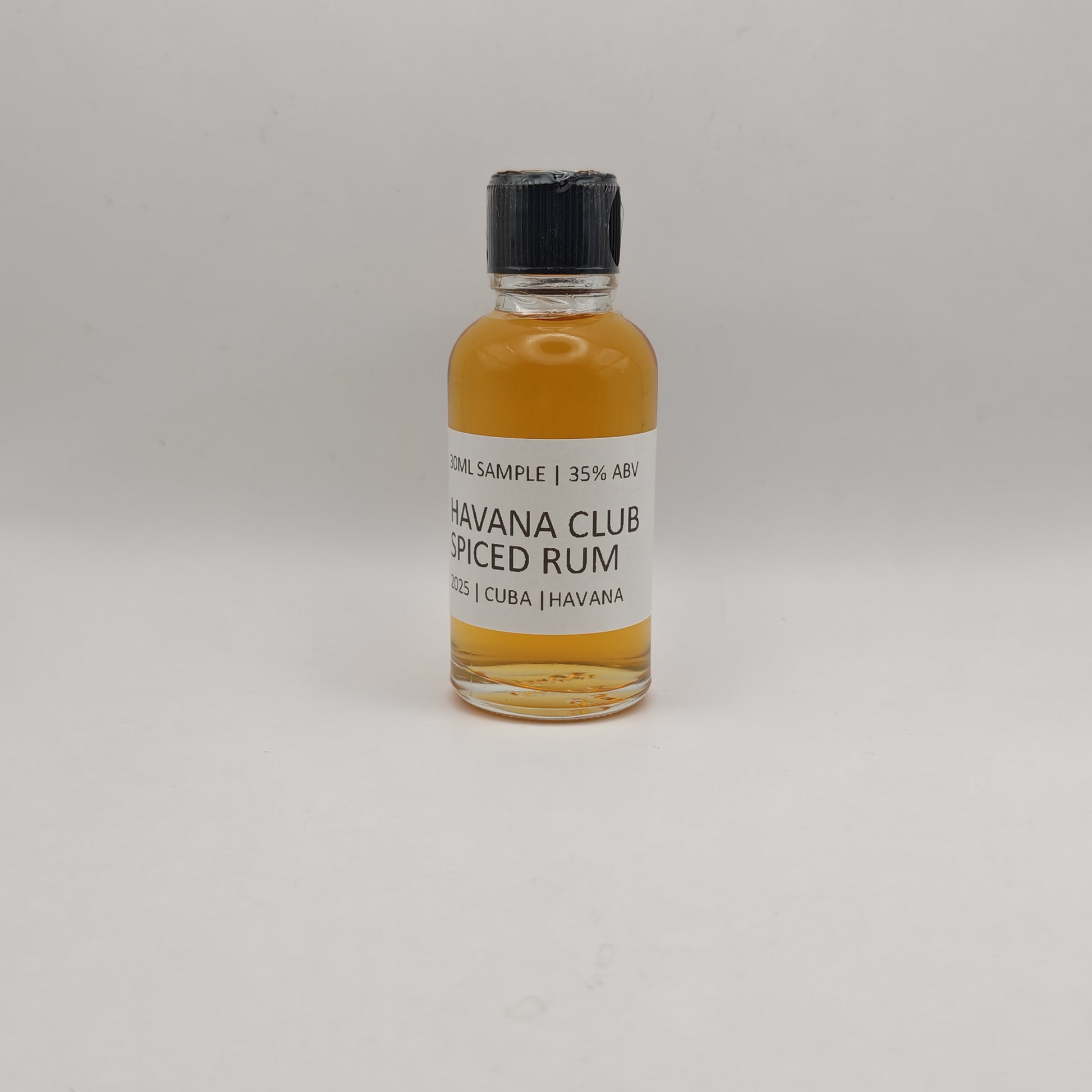 Small bottle of Havana Club Spiced Rum on a light gray background