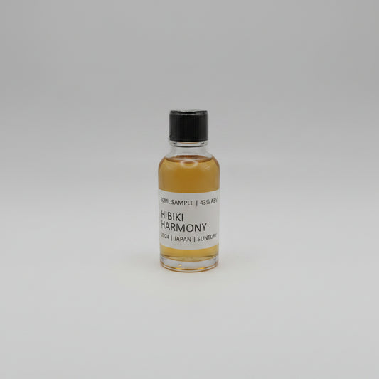 Small bottle of Hibiki Harmony whisky sample on a light gray background