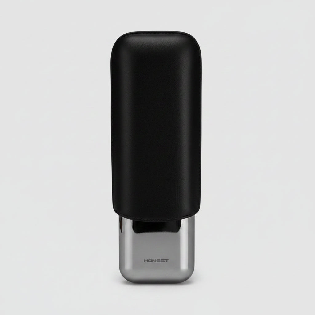 A black rectangular CIGAR case with a glossy silver metallic cap, shown on a light gray background. The brand name 'HONEST' is printed on the silver cap.