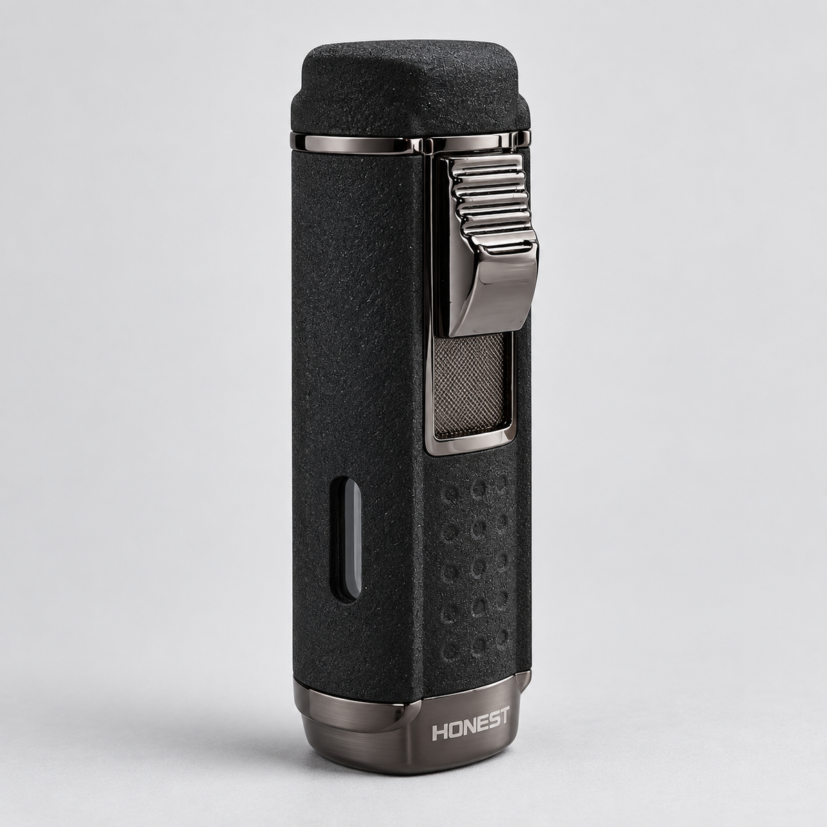 A black textured cigar lighter with a silver metal clip and base, featuring the brand name 'HONEST' on the bottom, set against a light gray background.