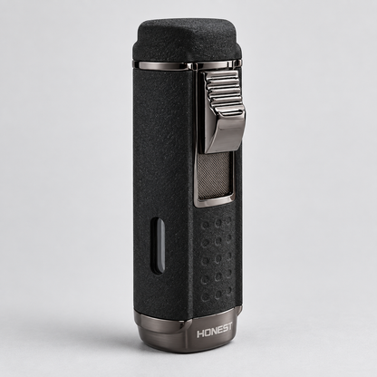 A black textured cigar lighter with a silver metal clip and base, featuring the brand name 'HONEST' on the bottom, set against a light gray background.