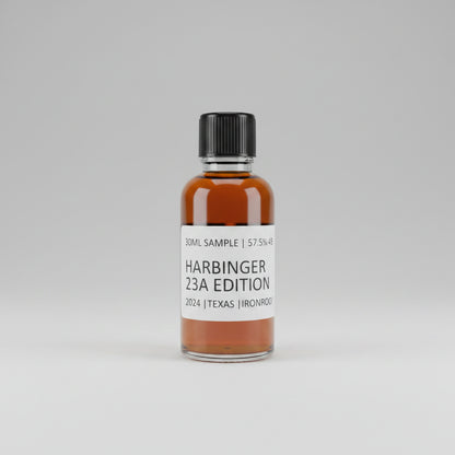 Bottle of Harbinger 23A Edition whiskey on a reflective surface with blurred background