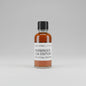Bottle of Harbinger 23A Edition whiskey on a reflective surface with blurred background