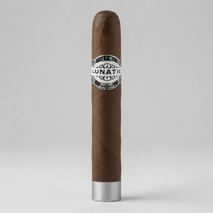 A single brown cigar standing upright on a light gray background, featuring a silver and black 'LUNATIC' band around the center and a silver metal tip at the bottom.