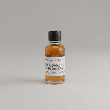 Small bottle of Jack Daniel's 1989 Vintage on a light pink background