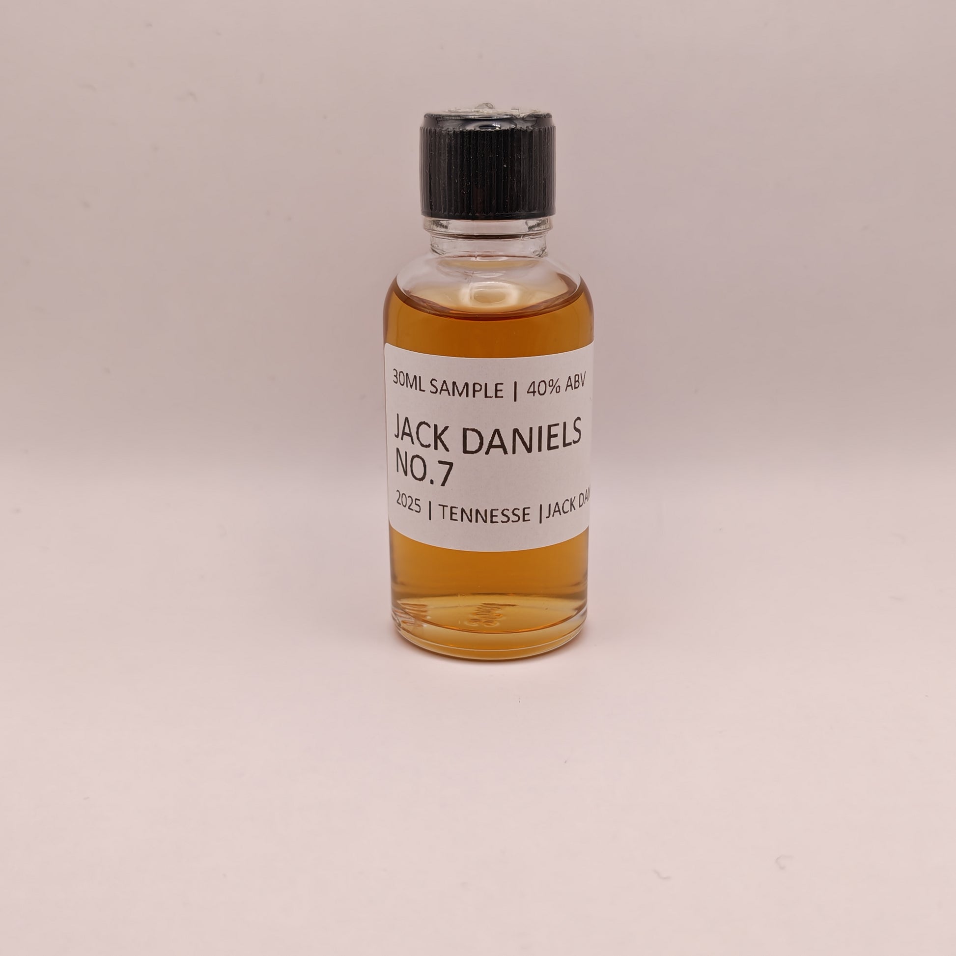 Small bottle of Jack Daniel's No. 7 on a beige background