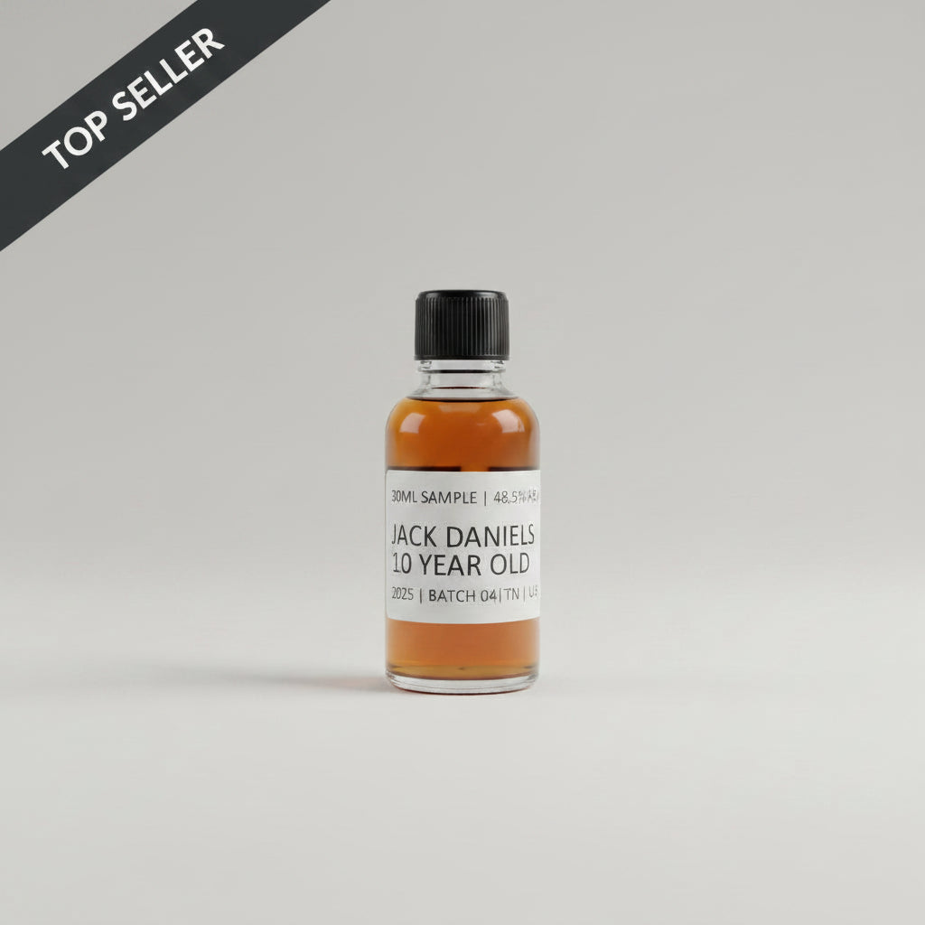 Small bottle of Jack Daniel's 10 Year Old whiskey on a reflective surface with a blurred background.