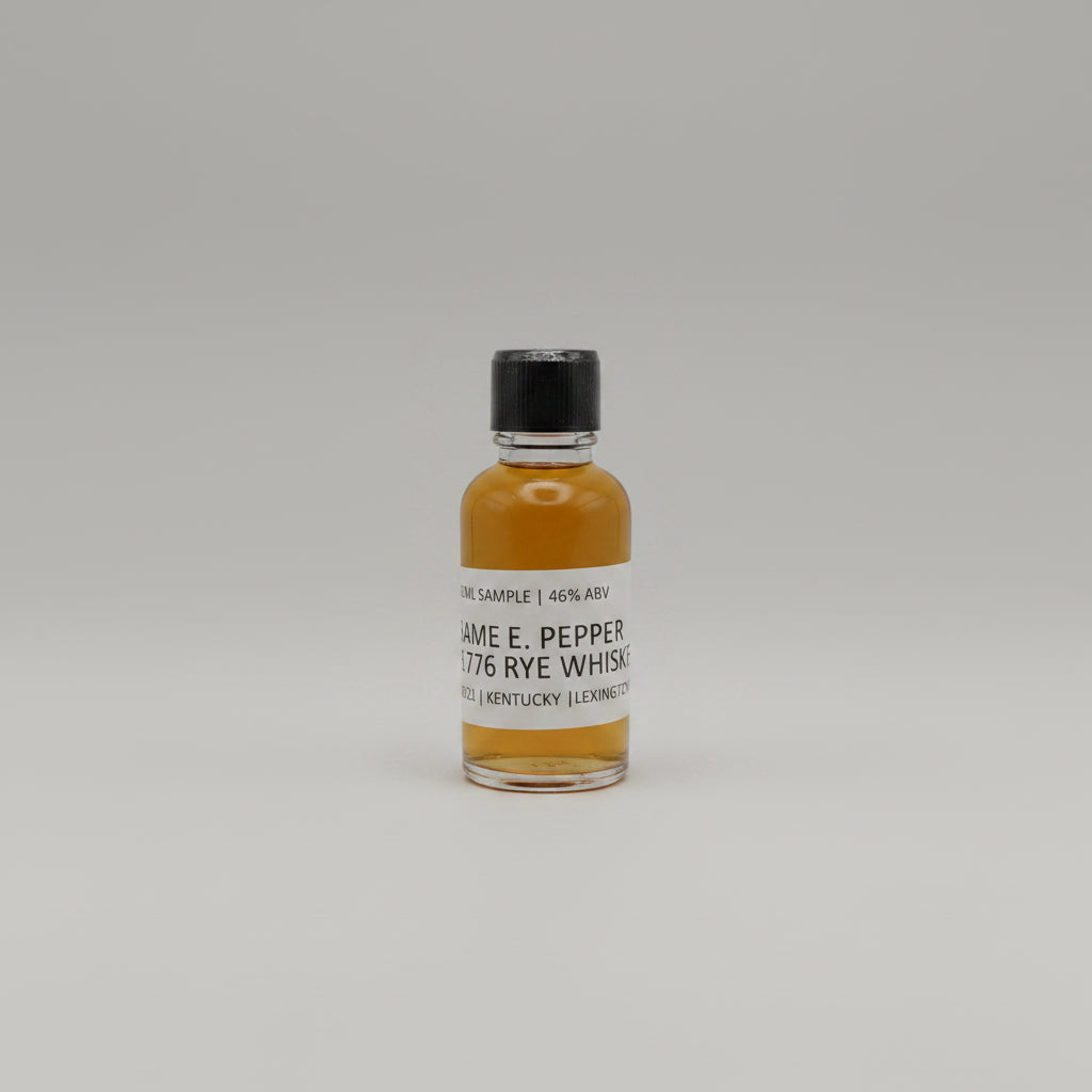 Small bottle of James E. Pepper 1776 Rye Whiskey on a white background