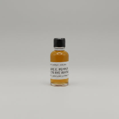 Small bottle of James E. Pepper 1776 Rye Whiskey on a white background