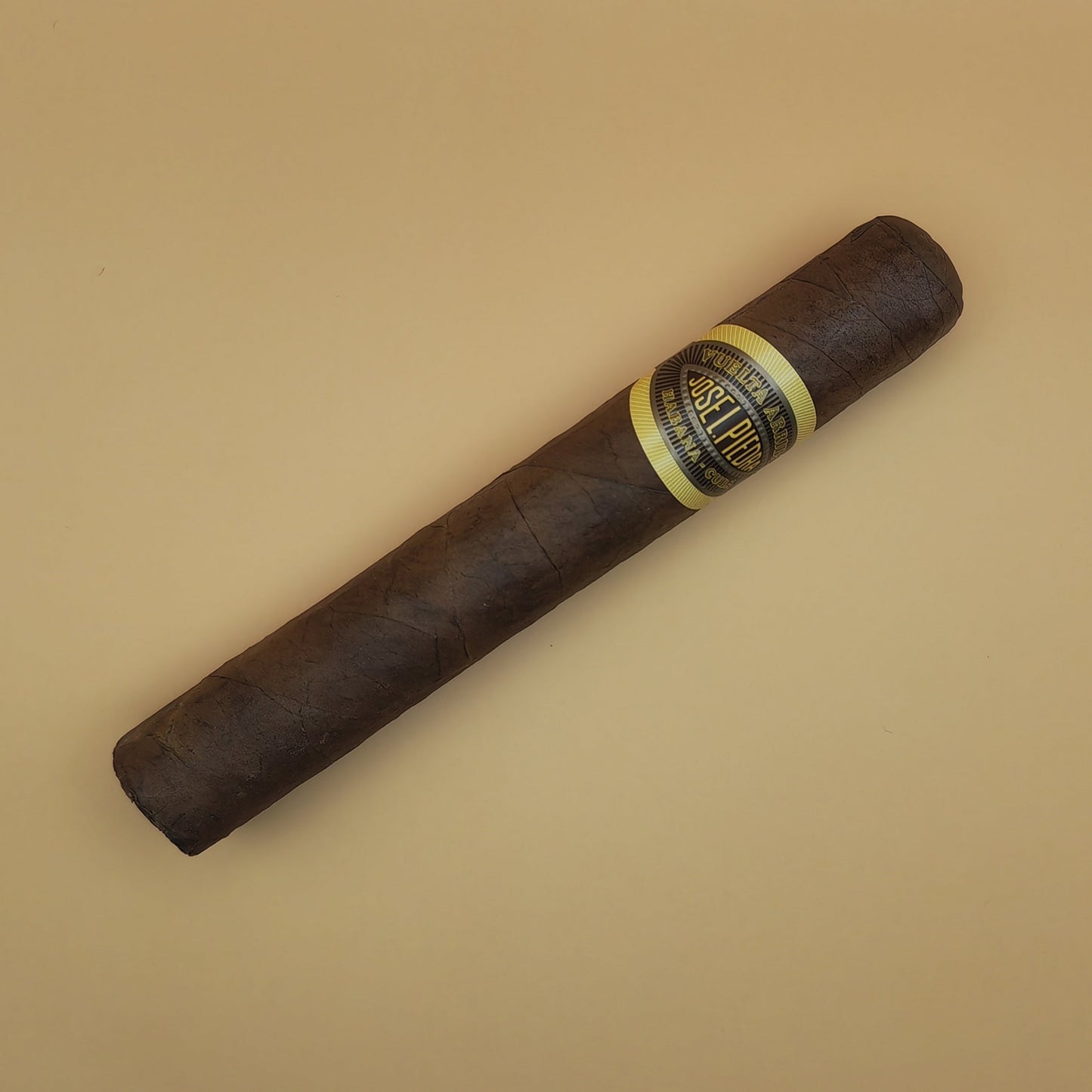 Cigar with a band on a beige background