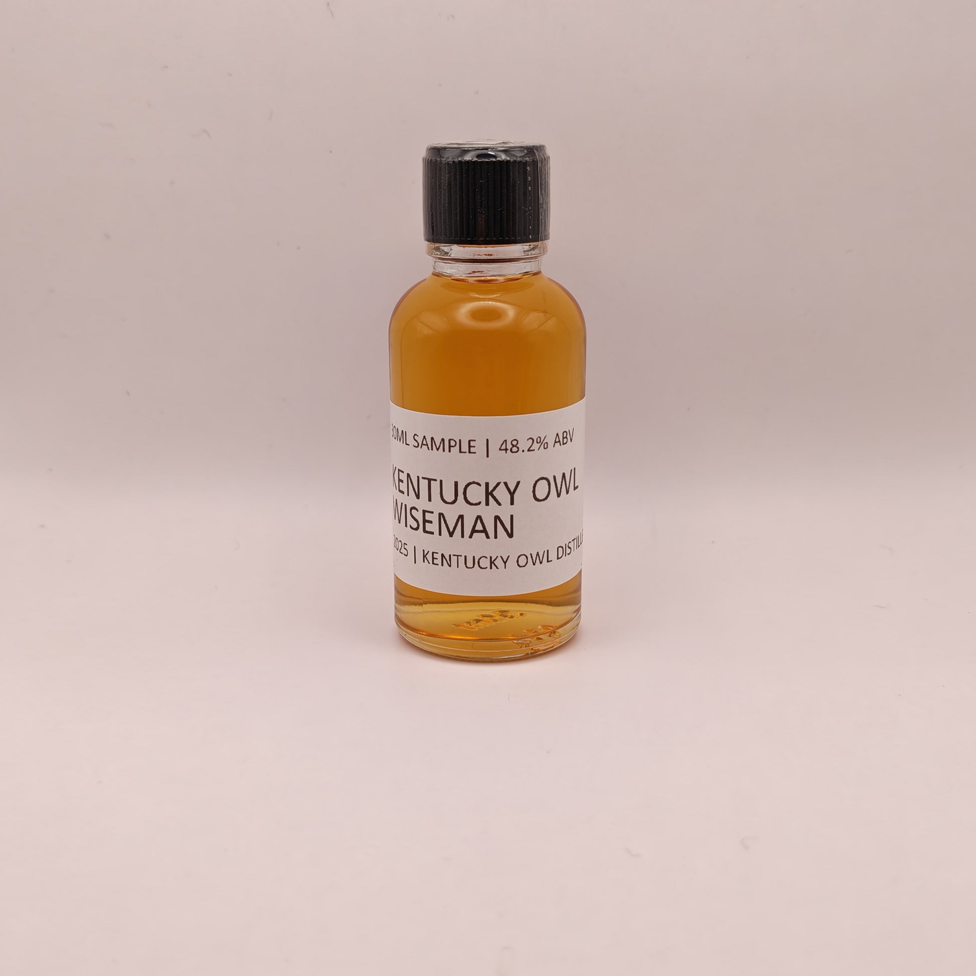 Small bottle of Kentucky Owl Wiseman on a light gray background