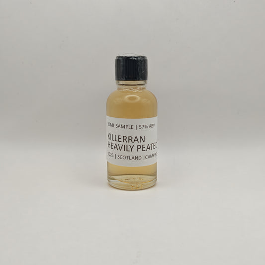 Bottle of Killerran Heavily Peated whisky sample on a light gray background