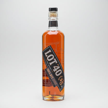 A bottle of Lot 40 Dark Rye 100% Rye Whiskey, showing the amber liquid inside a clear glass bottle with a black and orange label.