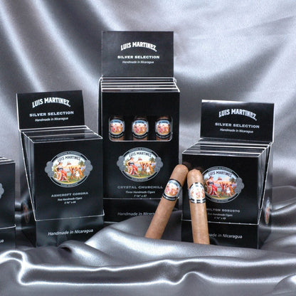 Louis Martinez Silver Selection cigars displayed with packaging on a gray fabric background