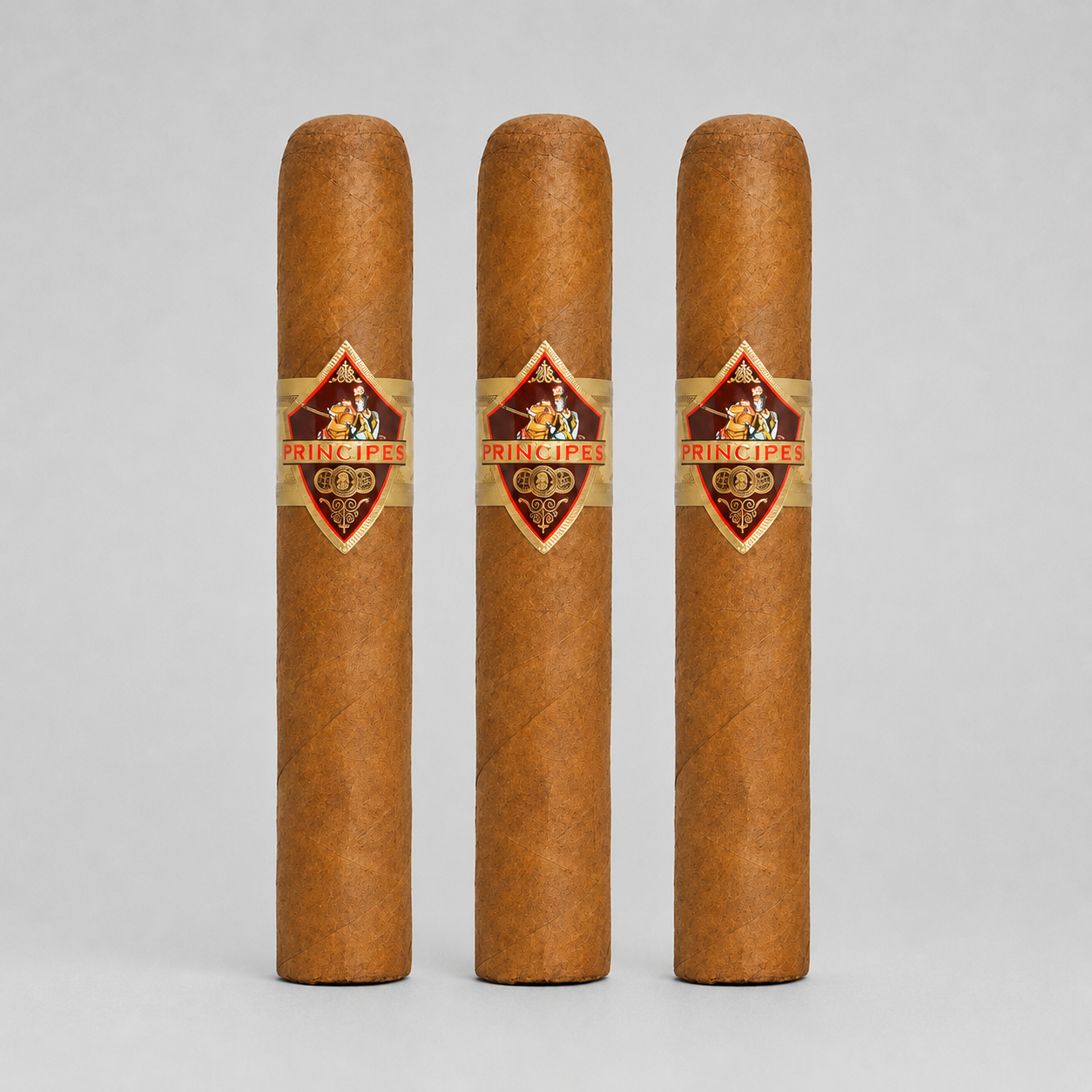 Three brown cigars standing upright side by side on a light gray background, each with a diamond-shaped Prince Fire band label.