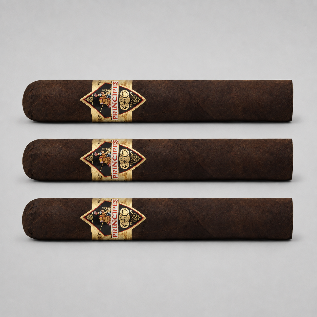 Three dark brown cigars arranged horizontally on a light gray background, each featuring a diamond-shaped gold and black Prince 500 band with red lettering.
