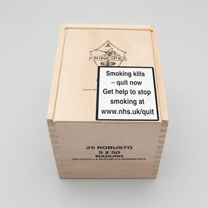 A wooden cigar box with a large warning label on the lid reading 'Smoking kills - quit now Get help to stop smoking at www.nhs.