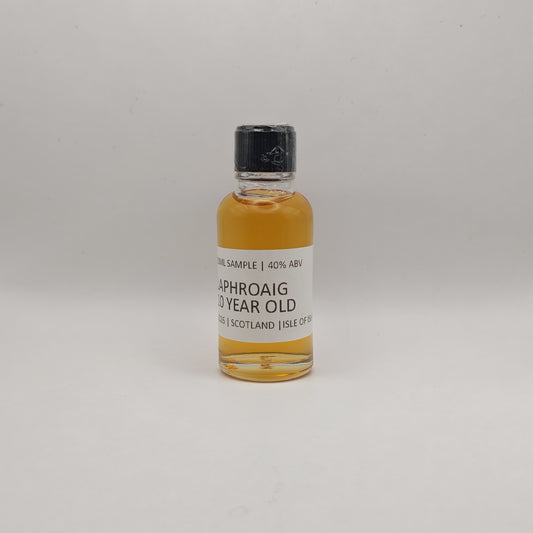 Small bottle of Laphroaig whisky sample on a gray background