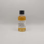 Small bottle of Laphroaig whisky sample on a gray background