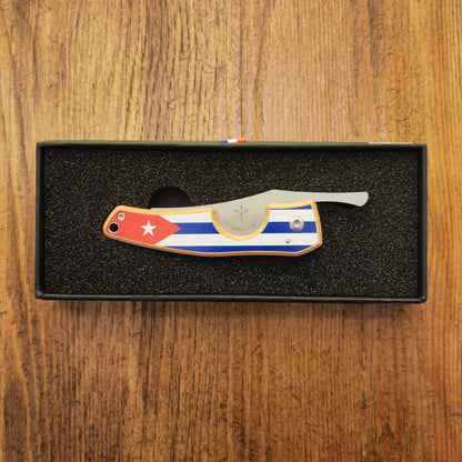 Folding knife with a flag design on a wooden surface