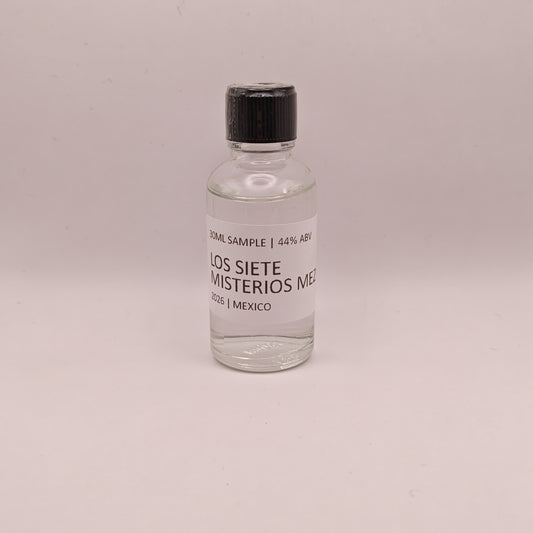 Small bottle of Los Siete Misterios Mezcal on a light gray background