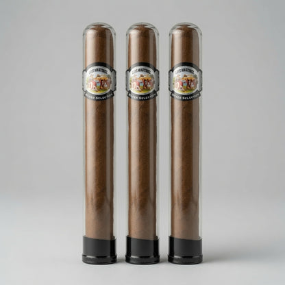 Three cigars in clear glass tubes with black bases, standing side by side on a light gray background. Each tube has a circular label reading 'Cigar Makers' and '70% Arabica'.