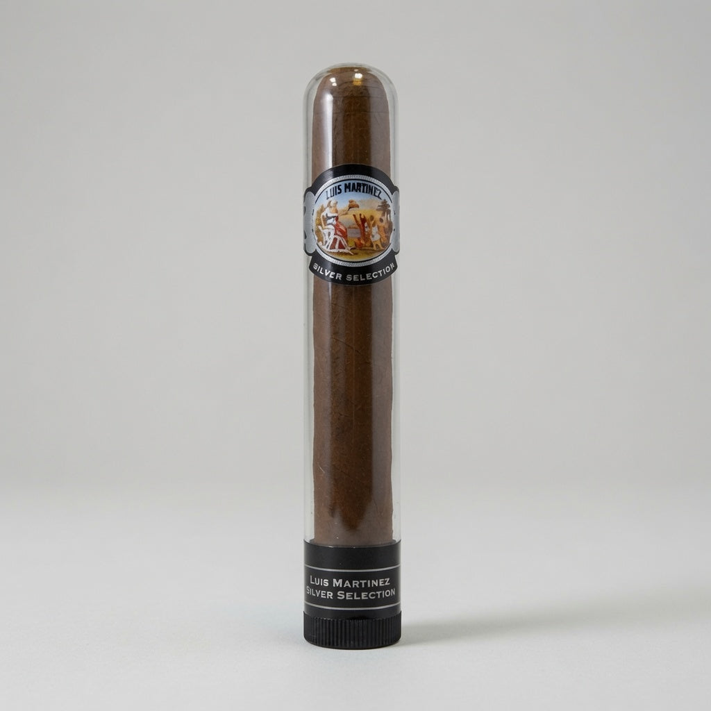 A single cigar in a clear cylindrical display tube with a black base, photographed against a light gray studio background. The cigar is dark brown, and the tube features a circular label reading 'Louis Martinez Silver Selection'.