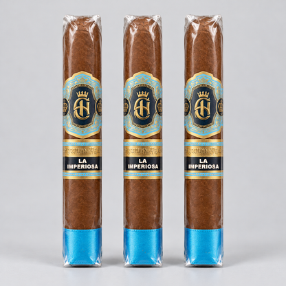 Three cigars in clear plastic wrapping with blue and gold labels reading 'LA IMPERIOSA' and a blue band at the base, shown against a light gray background.