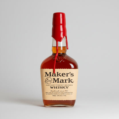 Maker's Mark Whisky bottle with a red cap on a white background