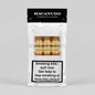 A package of Macanudo 3 Robusto Cigars on a light gray background. The white and black resealable pouch shows three cigars through a clear window, with a prominent smoking health warning label on the lower half.