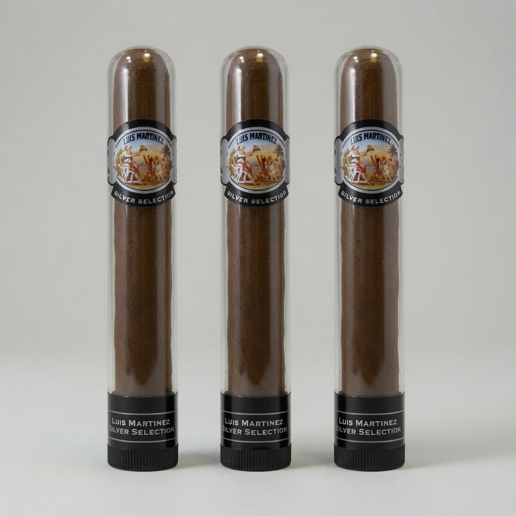 Three brown cigars in clear cylindrical tubes with black caps and circular Los Martinez Silver Selection labels, arranged side by side on a light gray background.